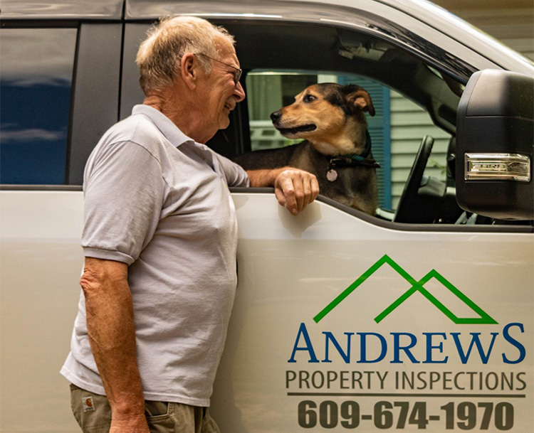Andrew Richards, owner of Andrews Property Inspections exchanges smiles with his pet dog sitting in his company truck
