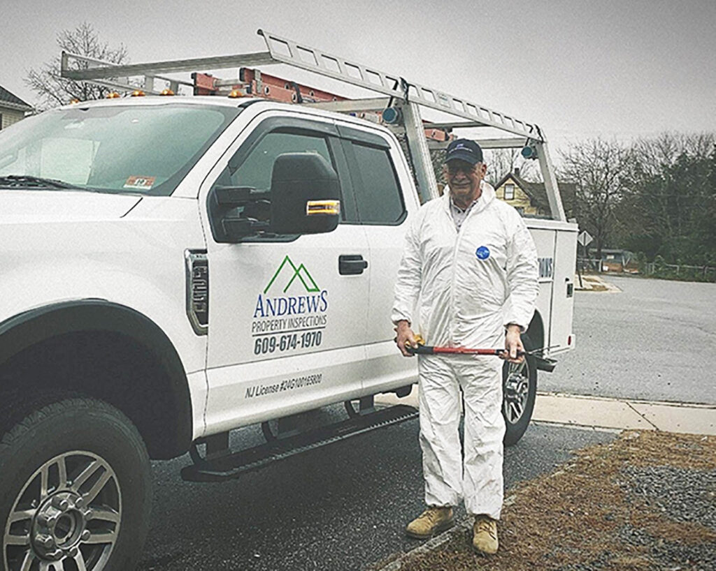 Property inspector, Richard Andrews stands beside his pickup truck on-site at an inspection
